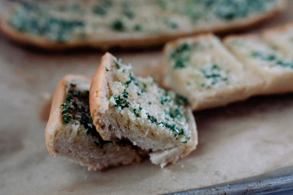 sliced sourdough garlic bread on a cutting board