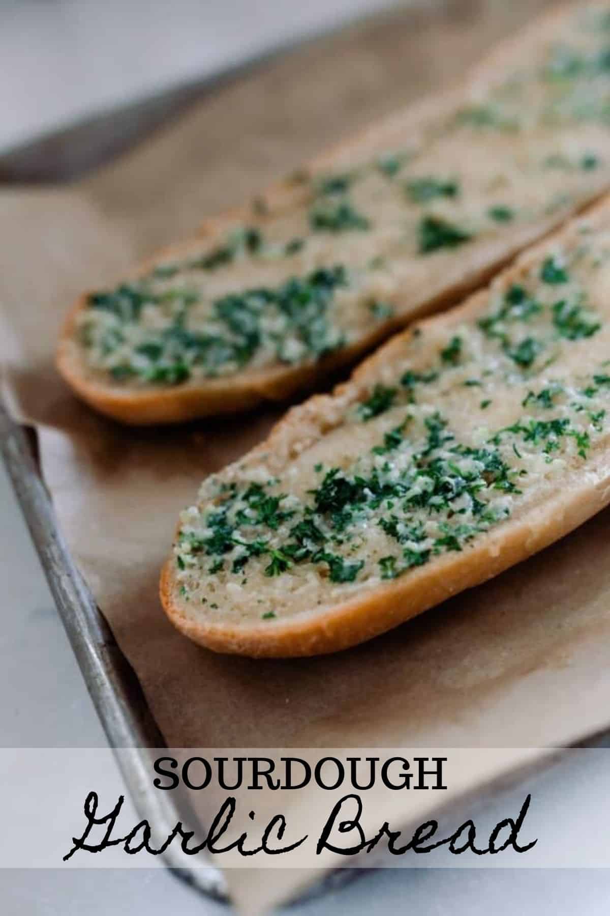 sourdough French bread cut in half and covered with garlic butter baked in the oven on parchment lined baking sheets
