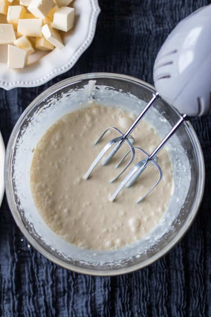 sourdough scone batter with a bowl of cubed butter in the background