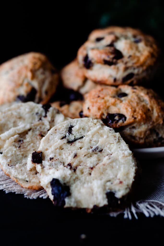 chocolate and coconut sourdough scones sliced in half with more scones stacked up in the background