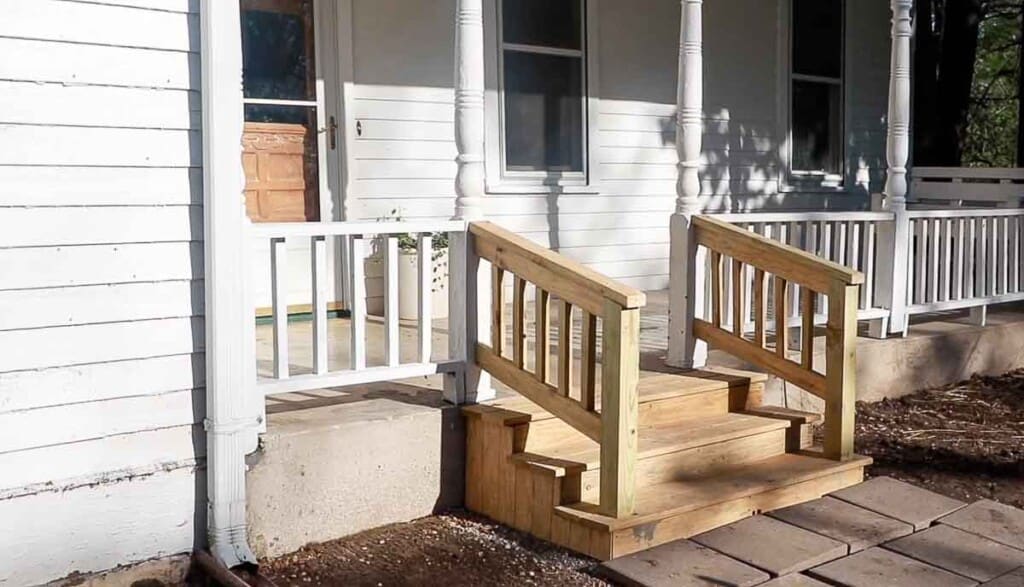 finished picture of front porch wood steps attached to a Victorian farmhouse front porch.