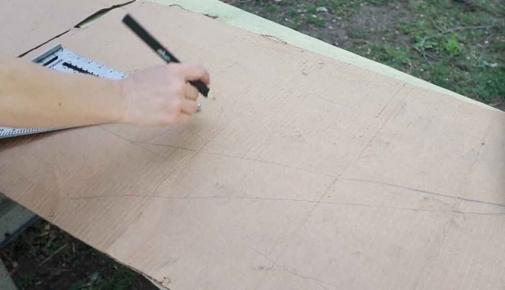 women using a framing square to mark out stair stringers on a piece of card board