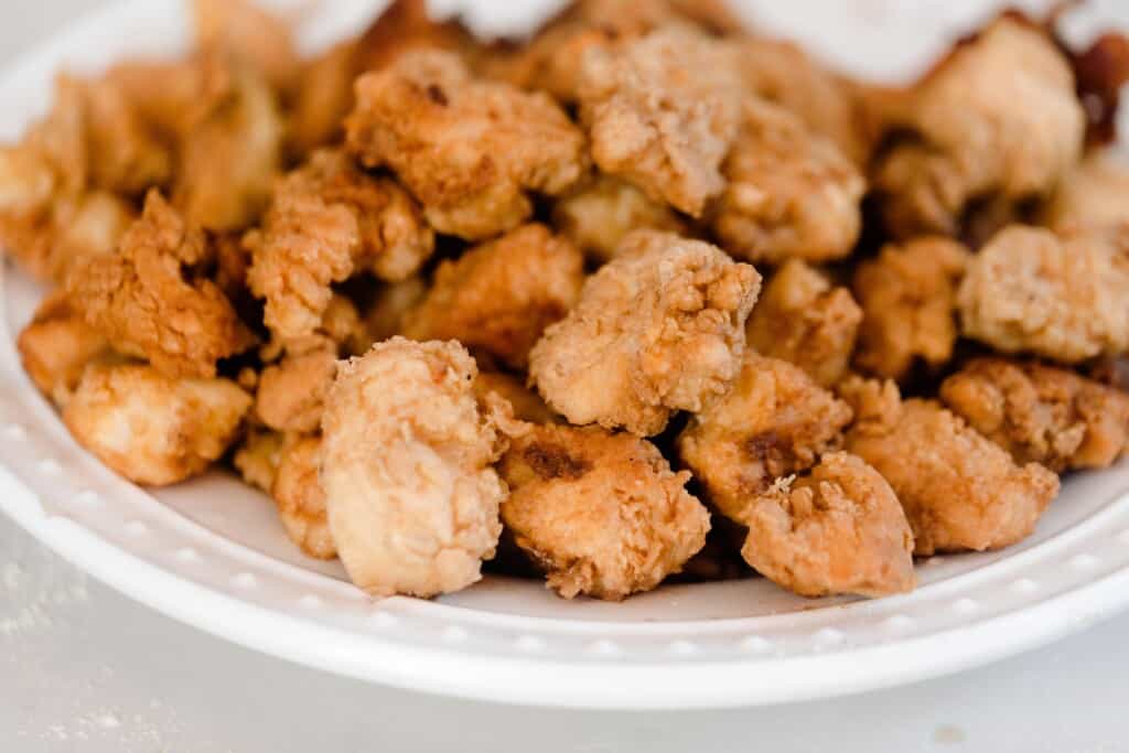 crispy fried chicken pieces on a white plate