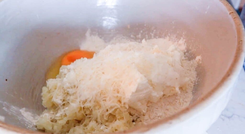 potato, egg, einkorn flour, ricotta and parmesan cheese in a large bowl