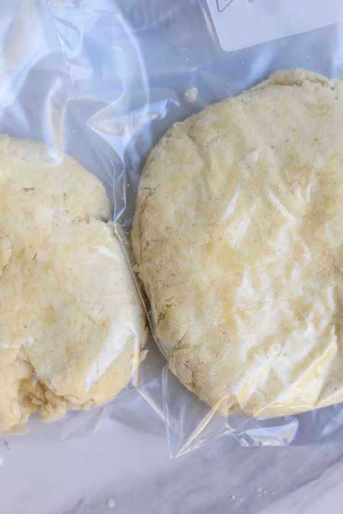 Two discs of pie dough in a plastic bag.