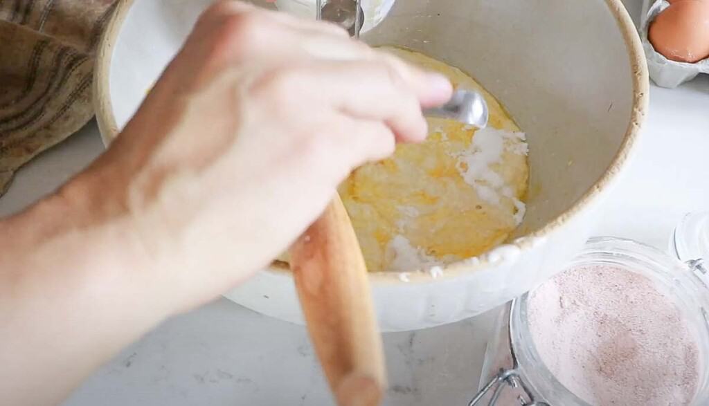 baking soda being added to sourdough cheddar waffle batter