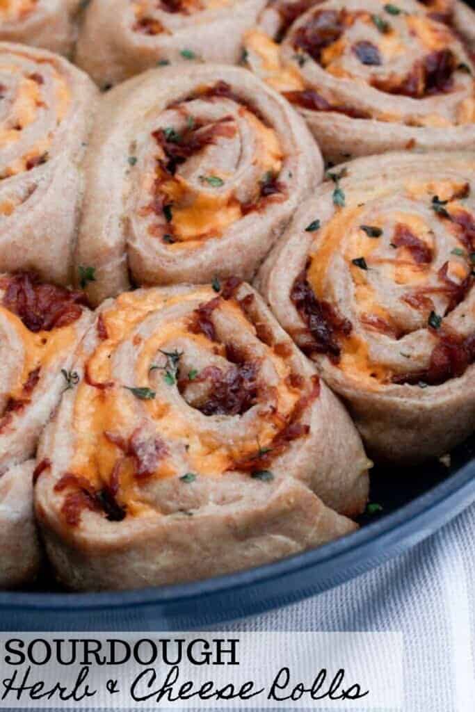 close up picture of sourdough cheese herbs rolls in a cast iron skillet