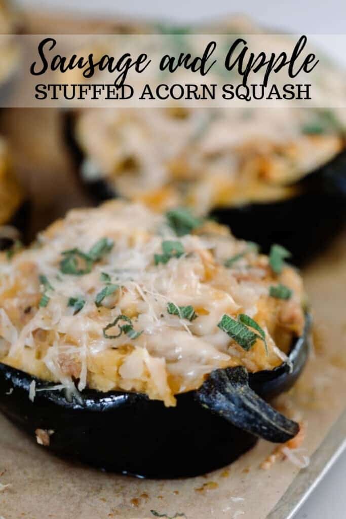 two stuffed acorn squashes topped with cheese on a wood cutting board