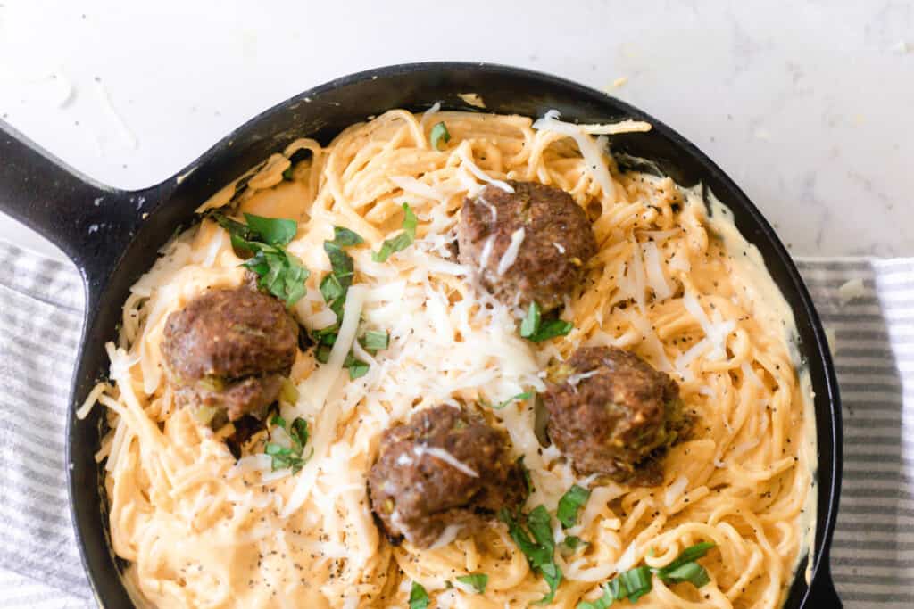 creamy pumpkin sauce tossed into spaghetti. Four meatballs nestled in the pasta and topped with cheese and fresh basil.