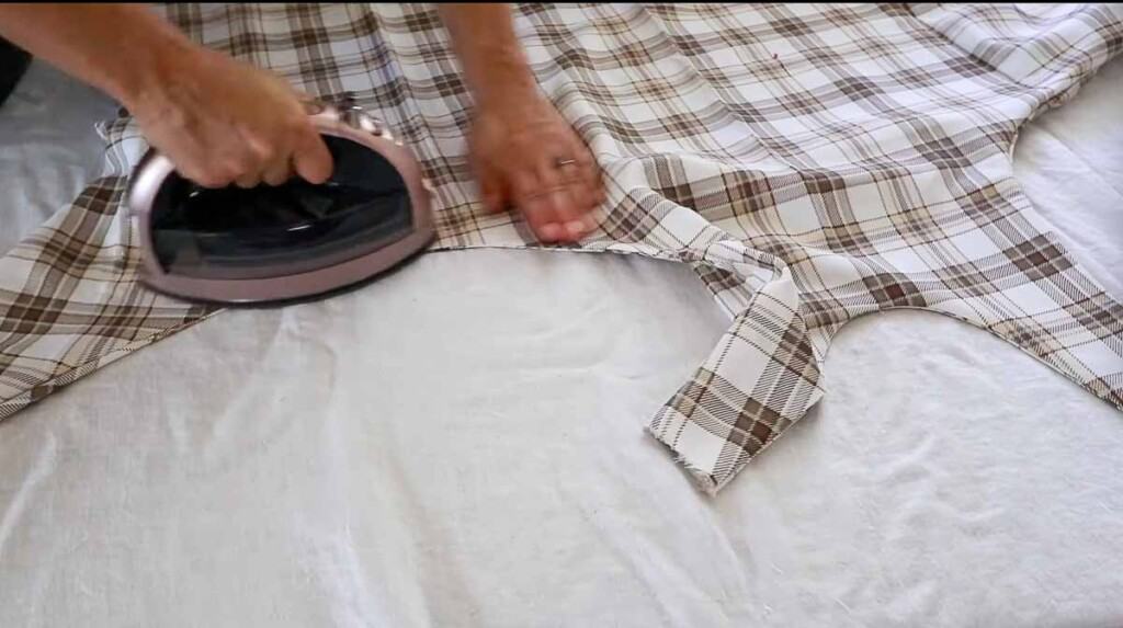 an plaid apron being pressed