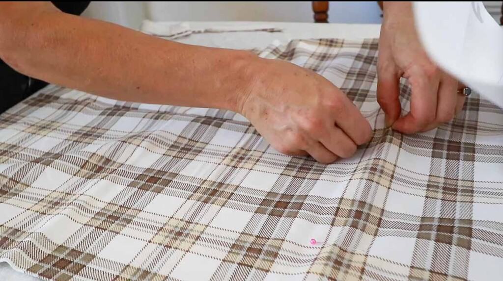 adding pins to the front of an apron to mark where the pockets should go.