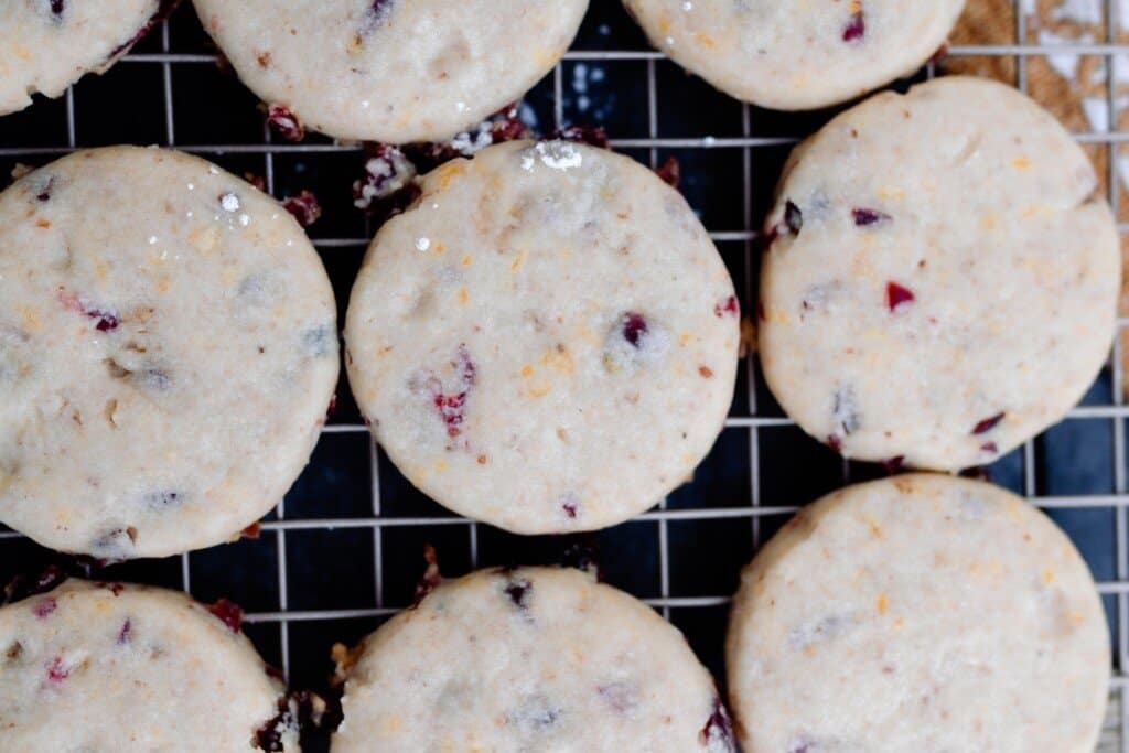 cranberry orange cookies cooling on a cookie rack