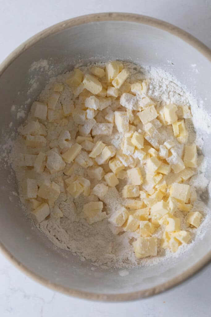 butter chopped in a bowl with flour