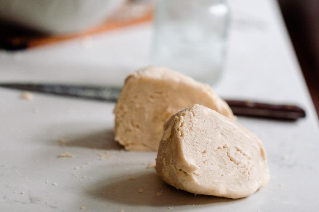 einkorn pie dough on a white countertop with a knife in the background