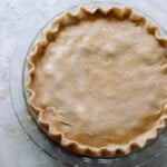 overhead photo of einkorn pie crust made into a pie on a white quartz countertop
