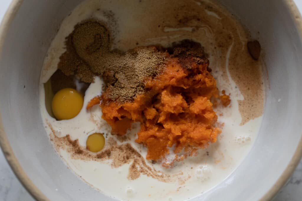 pumpkin pie filling in a cream colored bowl