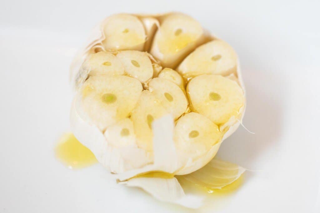 garlic a white baking dish drizzled with olive oil