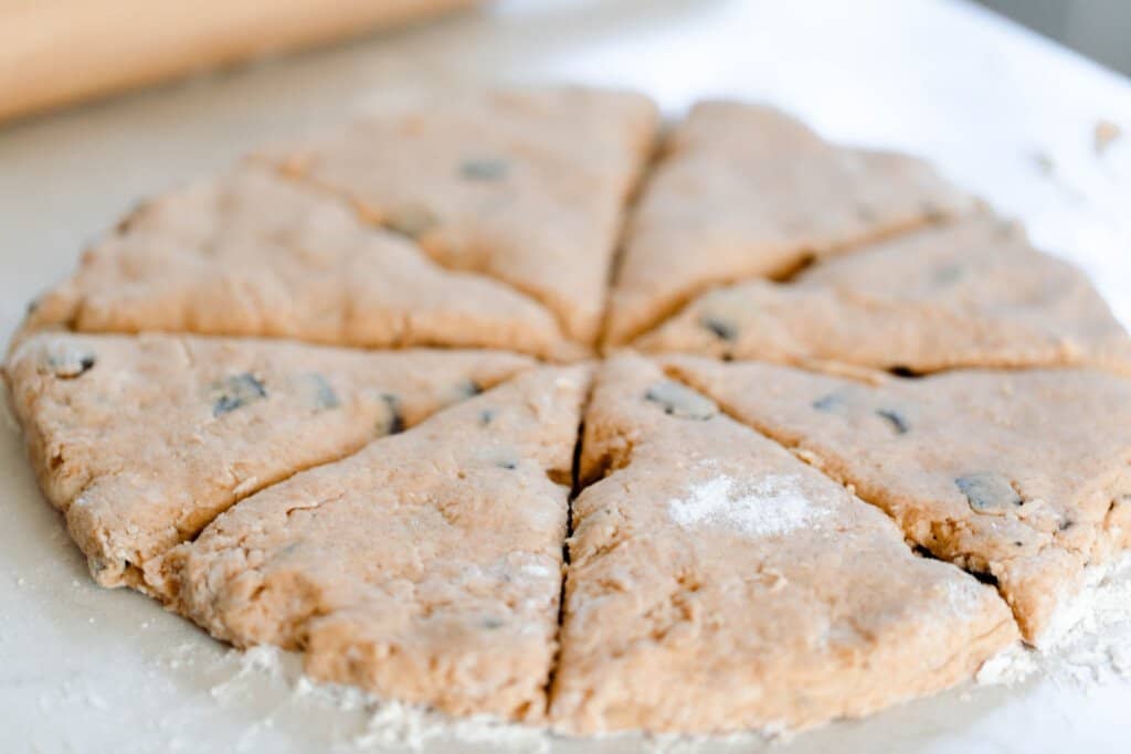 sourdough pumpkin scones patted out into a circle and cut into 8 equal pieces.