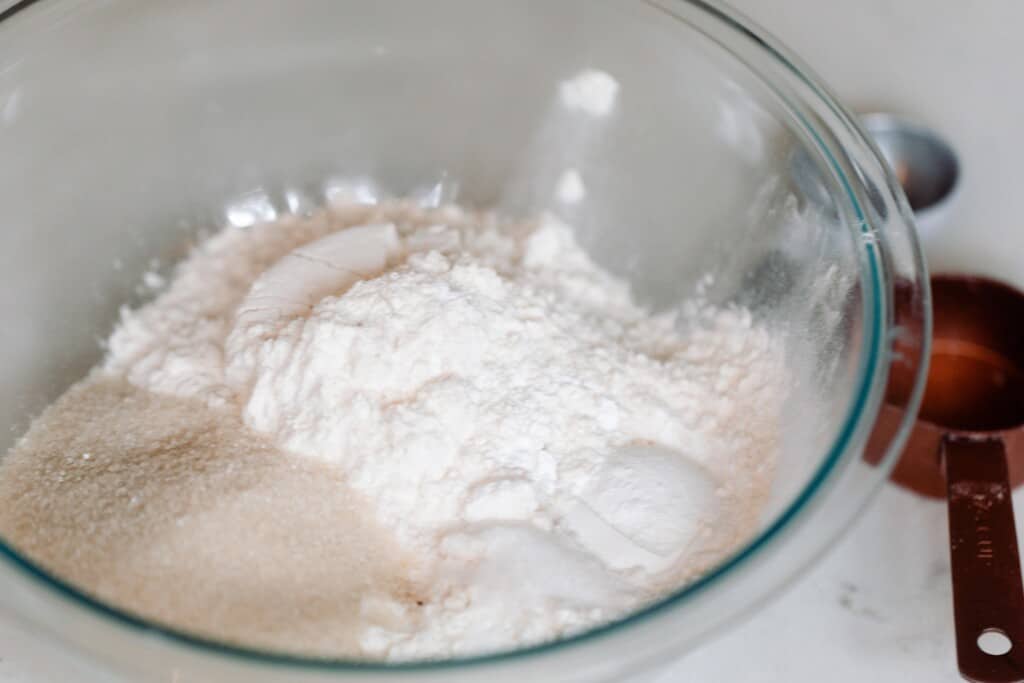 dry ingredients mixed together in a glass bowl on a white countertop
