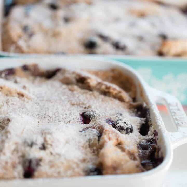 side view of two baking dishes of stuffed French toast casserole with blueberries