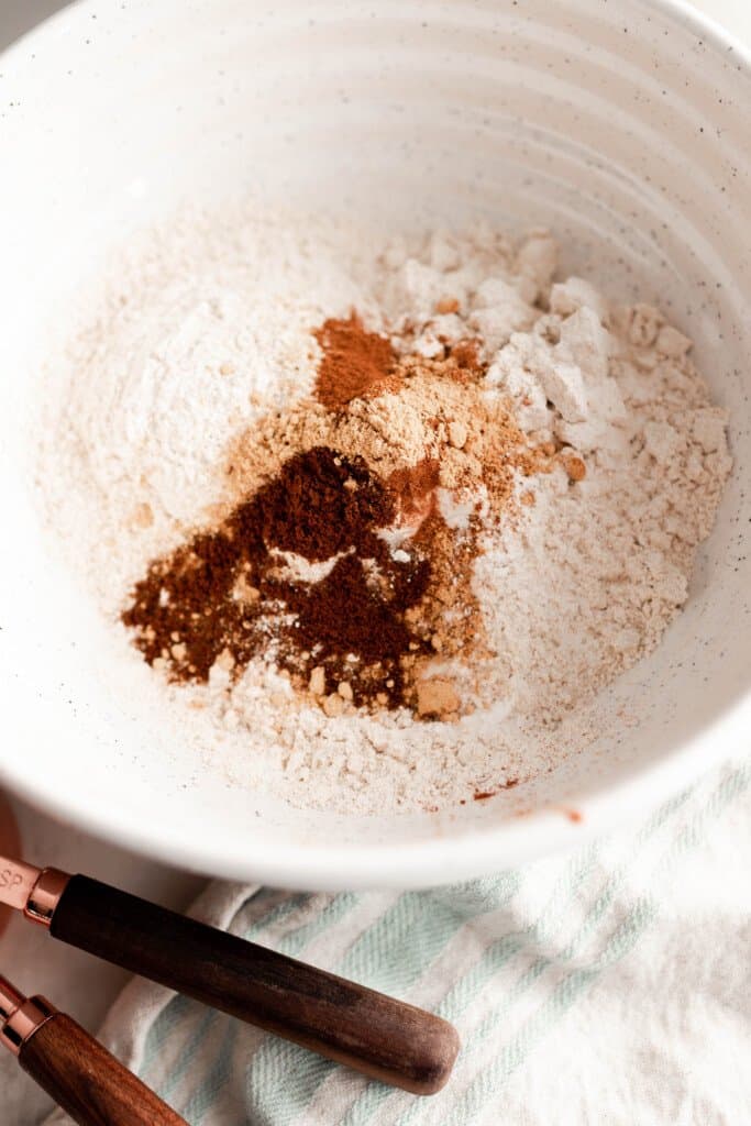 einkorn flour with spices and leavening agents in a stoneware bowl to waiting to be mixed up