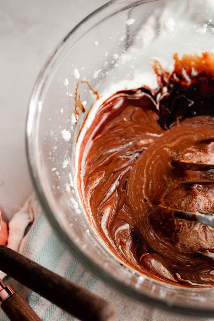 gingerbread cake batter in a glass bowl on a white countertop