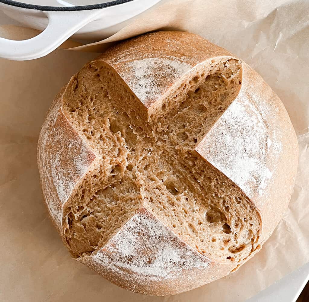 overhead photo of einkorn sourdough bread on. parchment paper