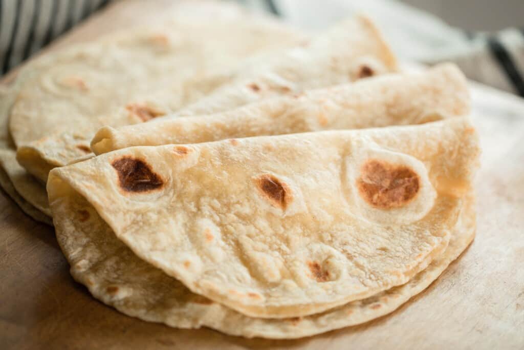 sourdough tortillas folded in half and layered over a countertop