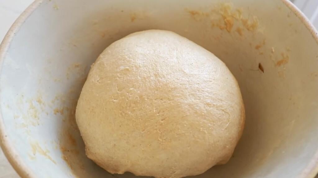 whole wheat sourdough bread dough in a ironstone bowl 