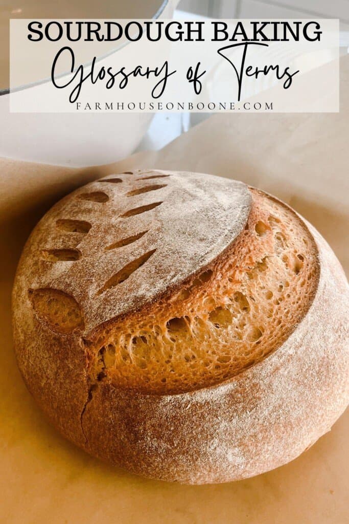 sourdough whole wheat bread with a wheat pattern on parchment paper