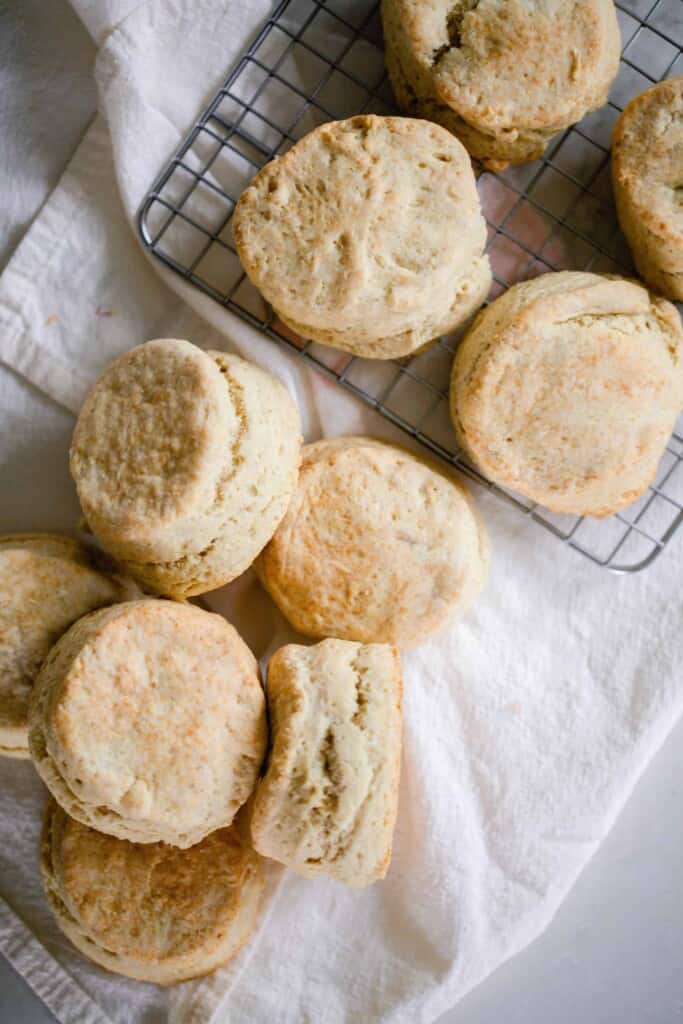 sourdough biscuits spread out on a linen towel and wire rack