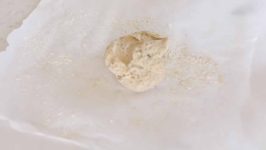 sourdough cracker dough on a piece of parchment paper