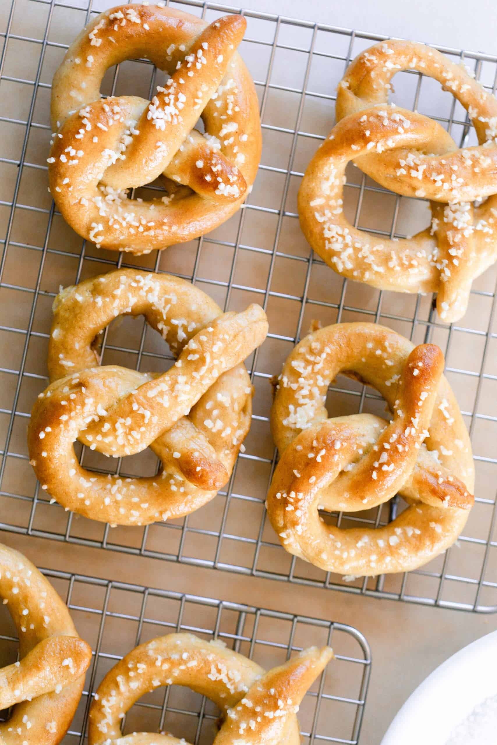 overhead photo of six sourdough pretzels on a wire cooling rack