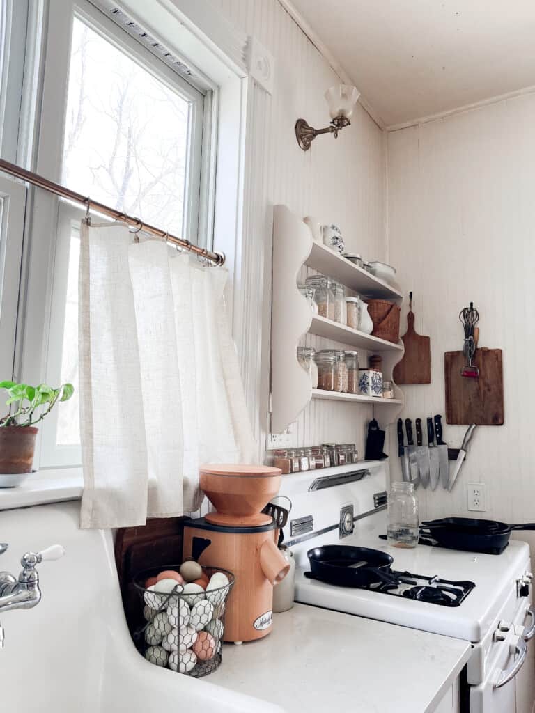 basket of eggs sitting on a white countertop next to a vintage sink