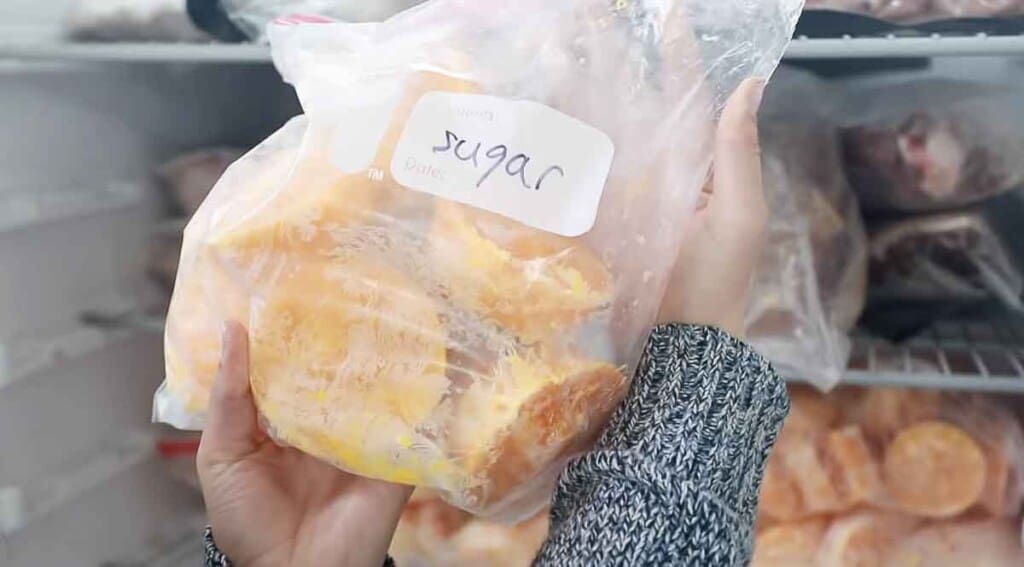 plastic bag labeled sugar with frozen eggs in it with a pinch of sugar