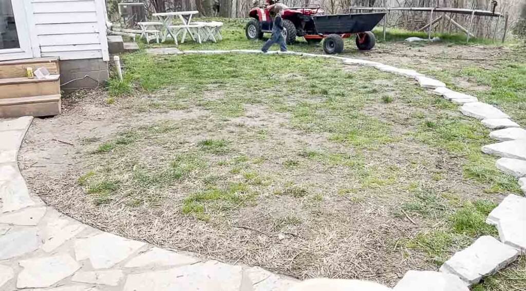 flagstone lining out a patio on grass