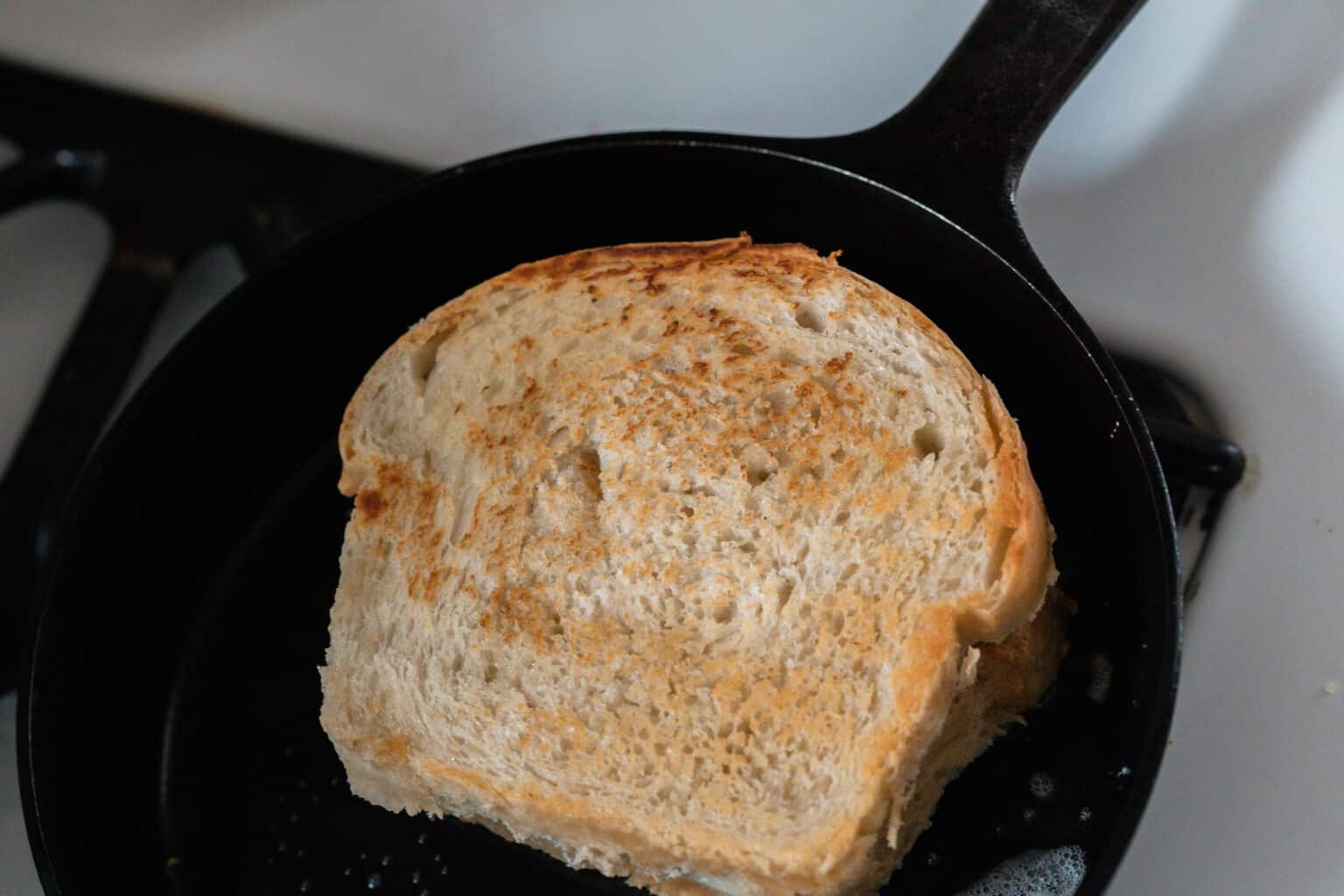 sourdough grilled cheese cookie gin a cast iron skillet.