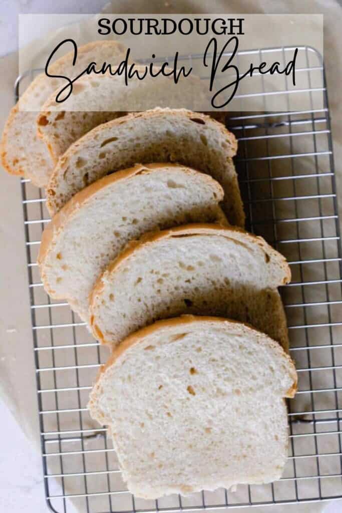 six slices of sourdough sandwich bread spread out on a wire rack over parchment paper