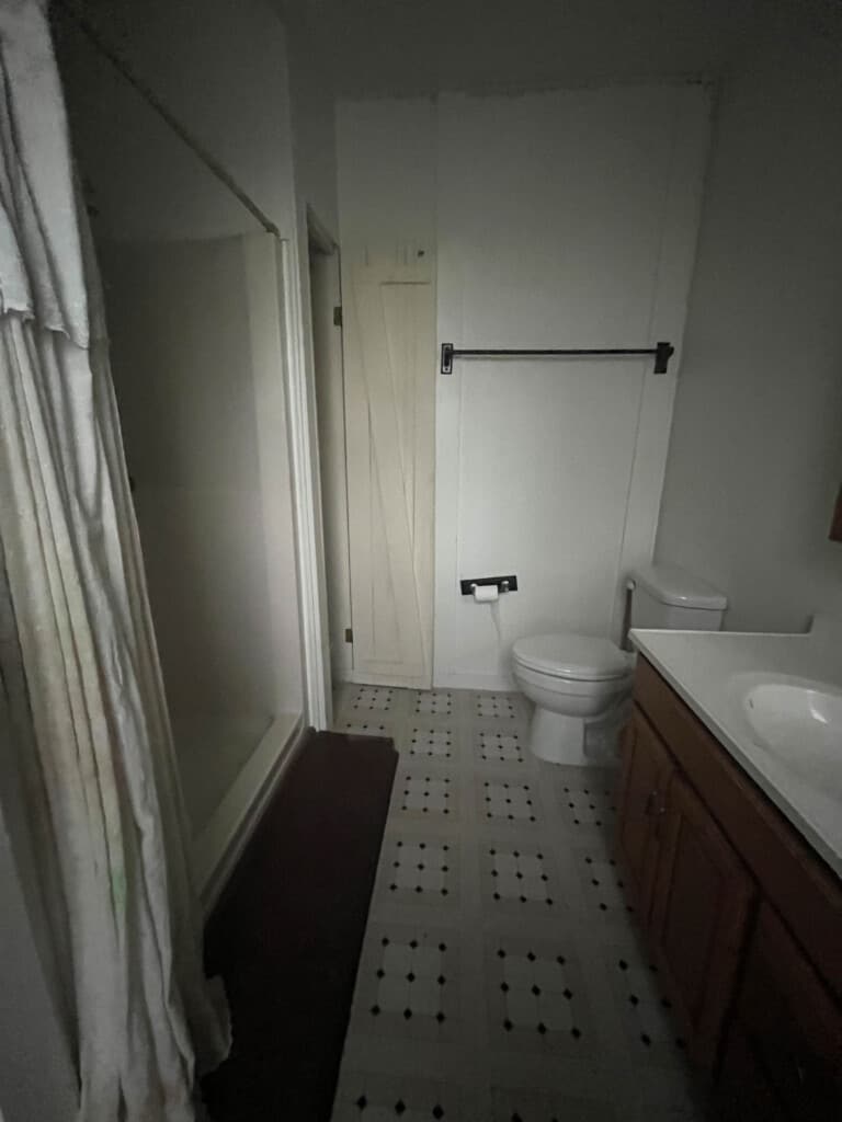 dated 80's bathroom with linoleum floors
