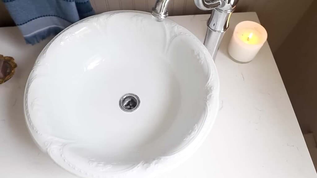 overhead photo of antique bowl turned into a sink on a marble countertop