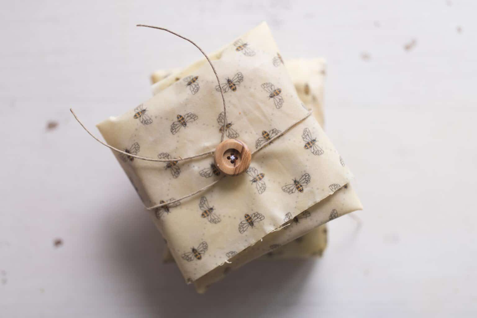 overhead photo of sandwiches wrapped in beeswax wraps with buttons and strings.