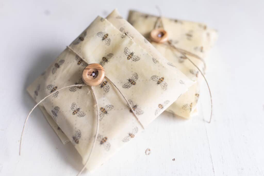sandwiches wrapped in beeswax wraps tied wit twine and a button.