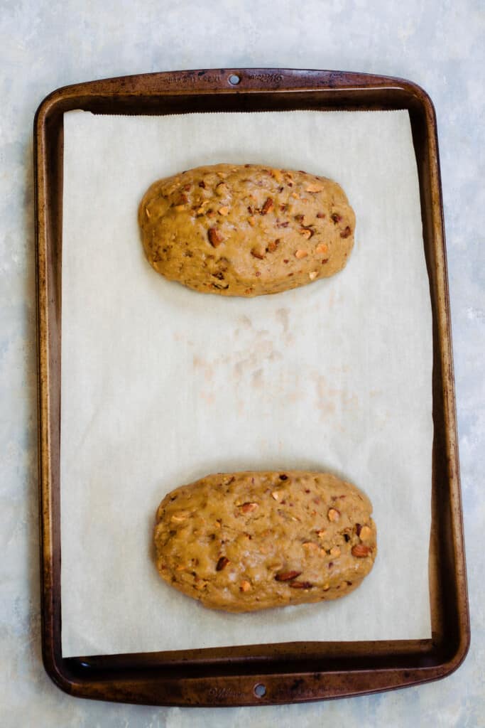sourdough biscotti dough shaped into two longs and place on parchment lined baking sheet