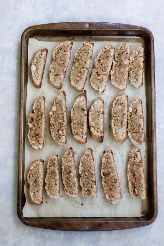sourdough almond biscotti placed on a parchment lined baking rack