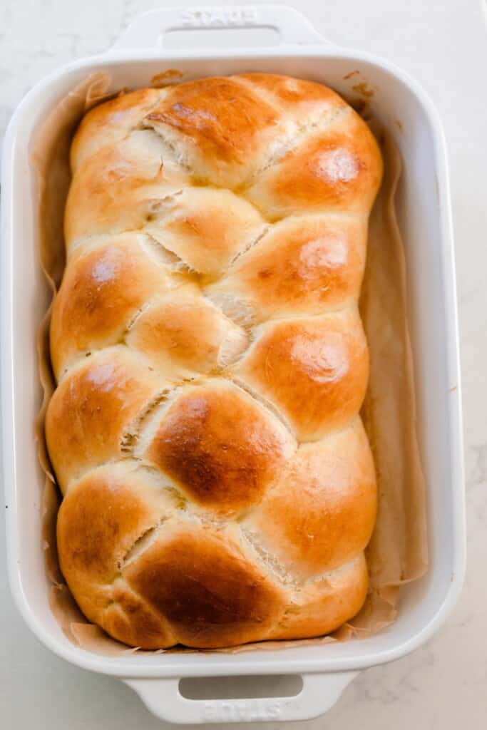 overhead photo of a loaf of fluffy and golden sourdough challah