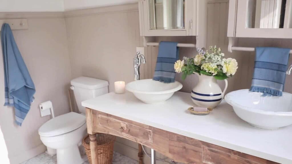 a homemade vanity made to look vintage with two vintage vessel sinks