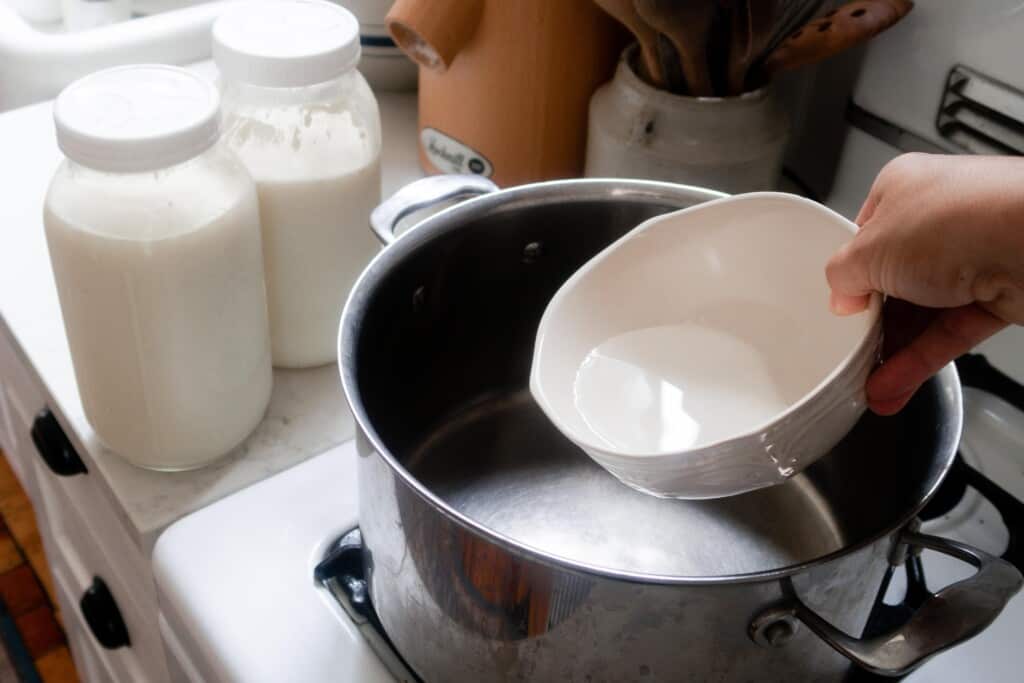 citric acid and water going into a large stainless pot