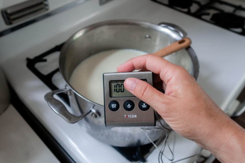 digital thermometer in a pot of milk and citric acid