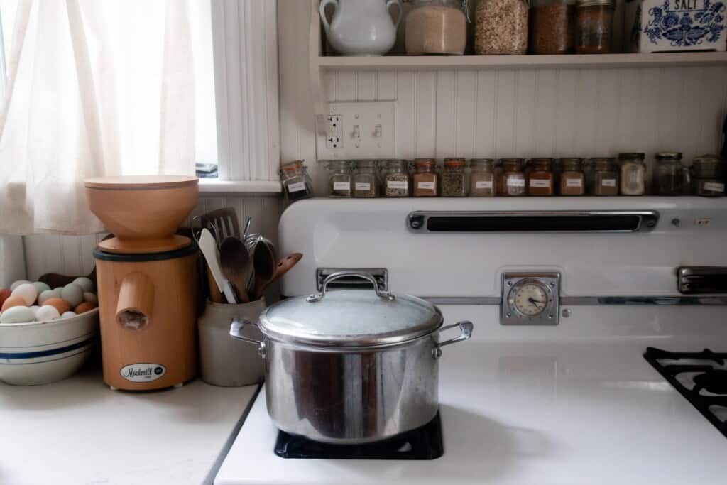 pot with lid on sitting on a white vintage stove