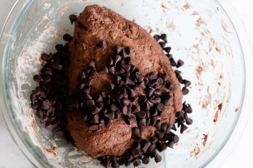 chocolate chips added to chocolate dough in a bowl